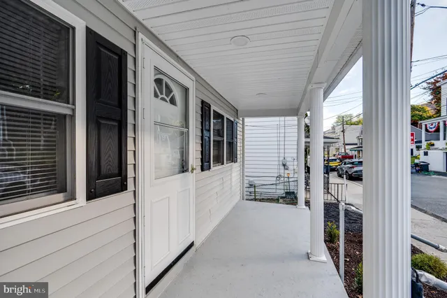 a view of a hallway with wooden walls and windows