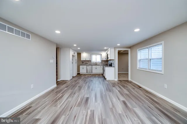 a view of a room with wooden floor and windows