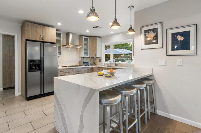 2549 Morley Way Sacramento, CA 95864 - Photo 14 of 44 a kitchen with stainless steel appliances a table chairs refrigerator and wooden cabinets