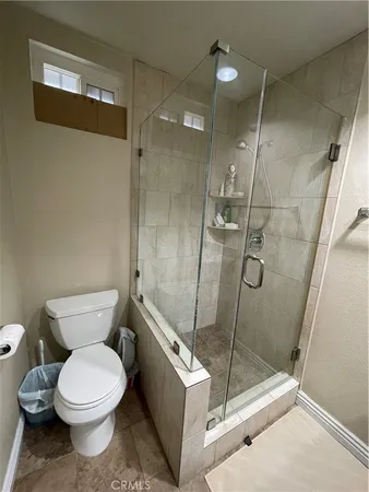 a bathroom with a toilet and a shower