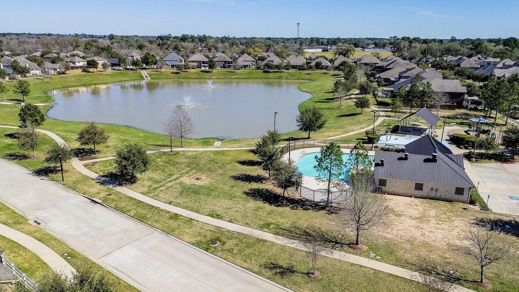 7042 Sliding Rock Circle Spring, TX 77379 - Photo 30 of 36 Stunning view of Twin Falls Community with serene lake and charming homes.