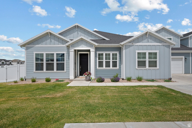 531 North Legend Way West, Unit D Mapleton, UT 84664 - Photo 2 of 42 View of front of property featuring board and batten siding, a front yard, a gate, and a garage