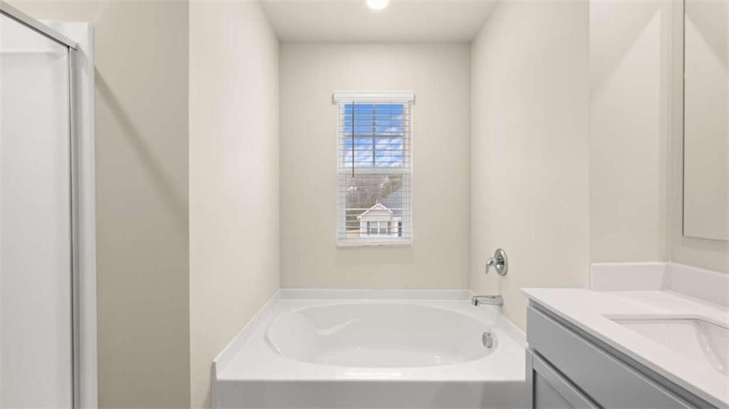 100 Planters Row Perry, GA 31069 - Photo 18 of 37 a white bath tub sitting next to a white sink