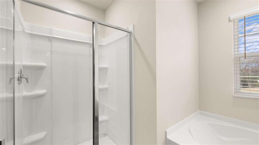100 Planters Row Perry, GA 31069 - Photo 19 of 37 a bathroom with a bathtub and a shower