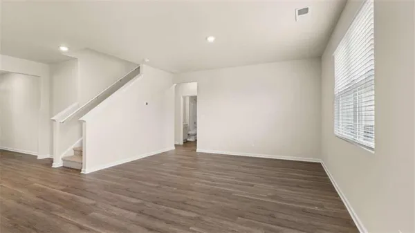 a view of kitchen with microwave and wooden floor