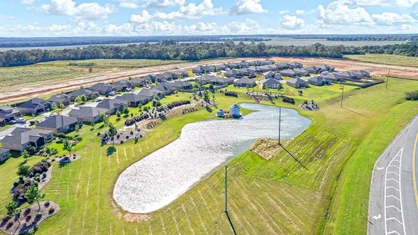an aerial view of a swimming pool with seating area