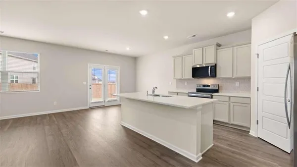 a kitchen with stainless steel appliances a refrigerator stove and microwave