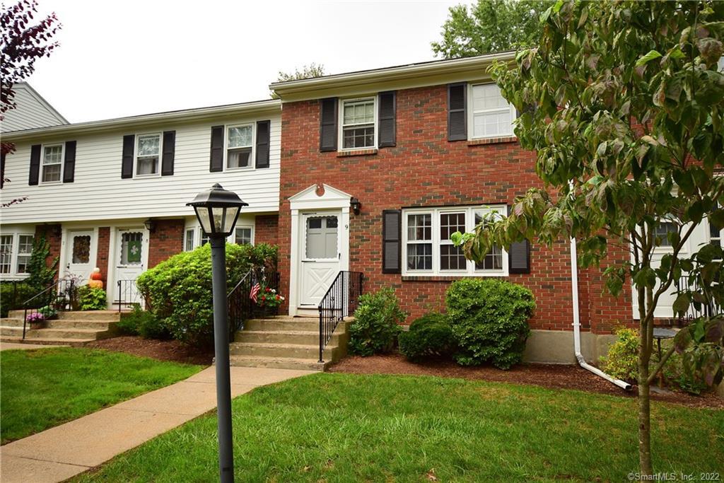 9 Brandywine Lane, Unit 9 Suffield, CT 06078 - Photo 1 of 1 a front view of a house with garden