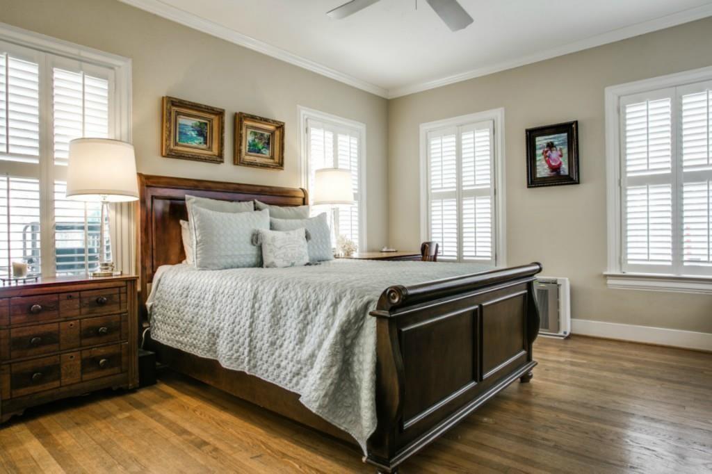 5419 Merrimac Avenue Dallas, TX 75206 - Photo 4 of 17 Room featuring wood-finish flooring, plantation shutters on multiple windows, neutral wall tones, crown molding, and a ceiling fan