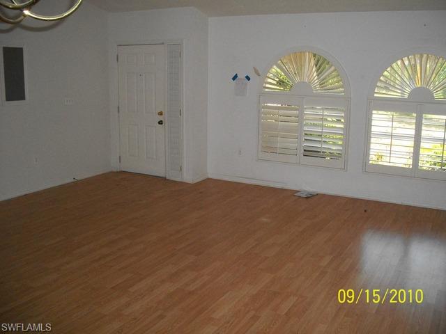 240 9th Street Southwest Naples, FL 34117 - Photo 3 of 8 wooden floor in an empty room with a window