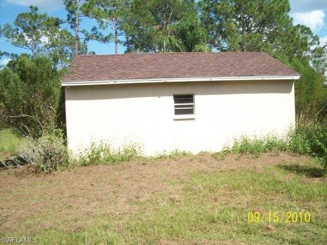 240 9th Street Southwest Naples, FL 34117 - Photo 7 of 8 a aerial view of a house with a yard