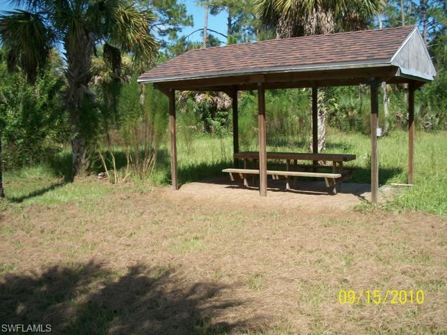 240 9th Street Southwest Naples, FL 34117 - Photo 8 of 8 a backyard of a house with a swing table and chairs