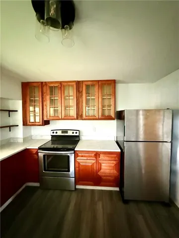 a kitchen with stainless steel appliances a stove a sink and a refrigerator