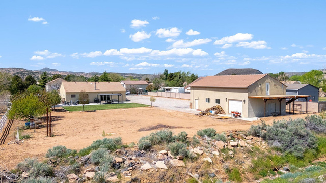 7776 Wagon Road East St. George, UT 84770 - Photo 68 of 76 View of yard featuring a patio, a mountain view, and dirt driveway
