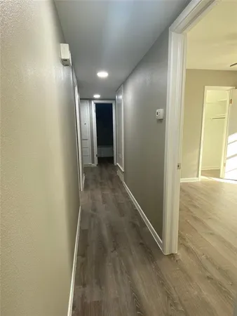 a view of hallway with wooden floor