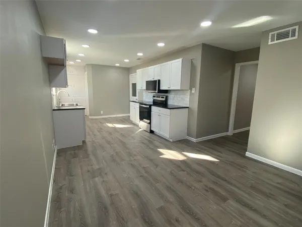 a view of kitchen with kitchen island microwave and stove