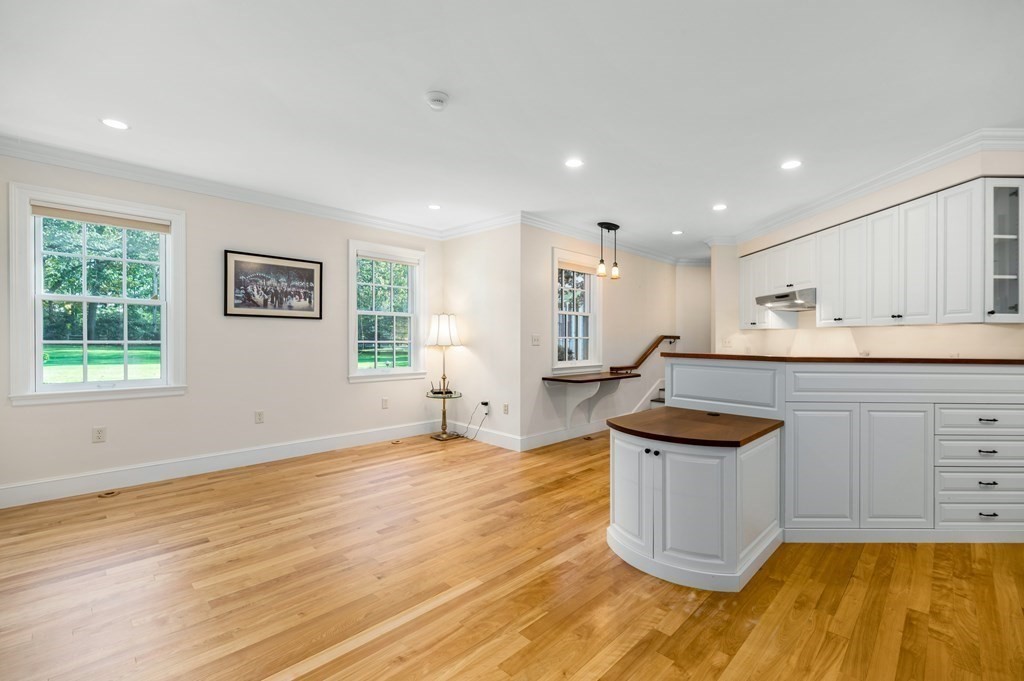 25 Haven Way Beverly, MA 01915 - Photo 28 of 42 a kitchen with stainless steel appliances granite countertop a sink and a stove with wooden floor
