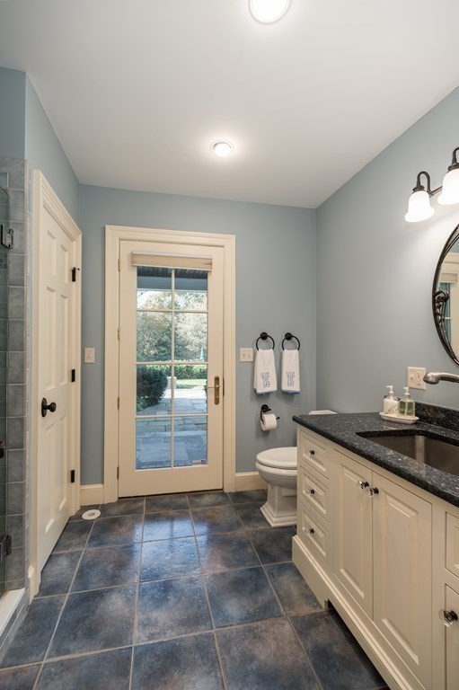 25 Haven Way Beverly, MA 01915 - Photo 36 of 42 a bathroom with a granite countertop sink a toilet and a window