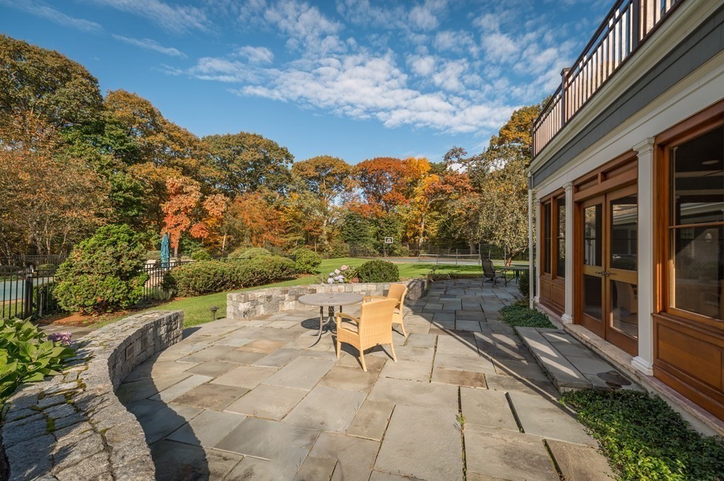 25 Haven Way Beverly, MA 01915 - Photo 40 of 42 a view of a patio with a table chairs and a floor to ceiling window