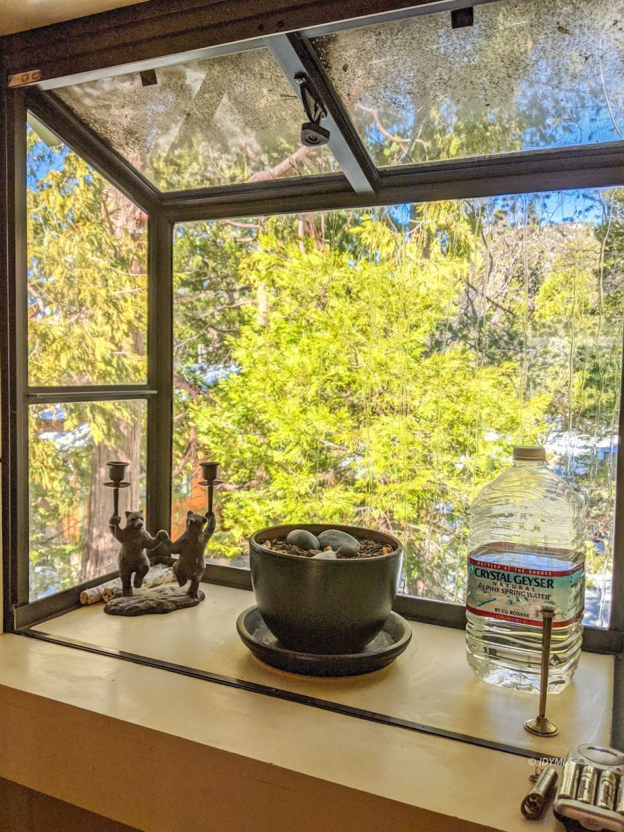 25505 Seneca Road Idyllwild, CA 92549 - Photo 22 of 60 a view of a living room with a floor to ceiling window and an outdoor view