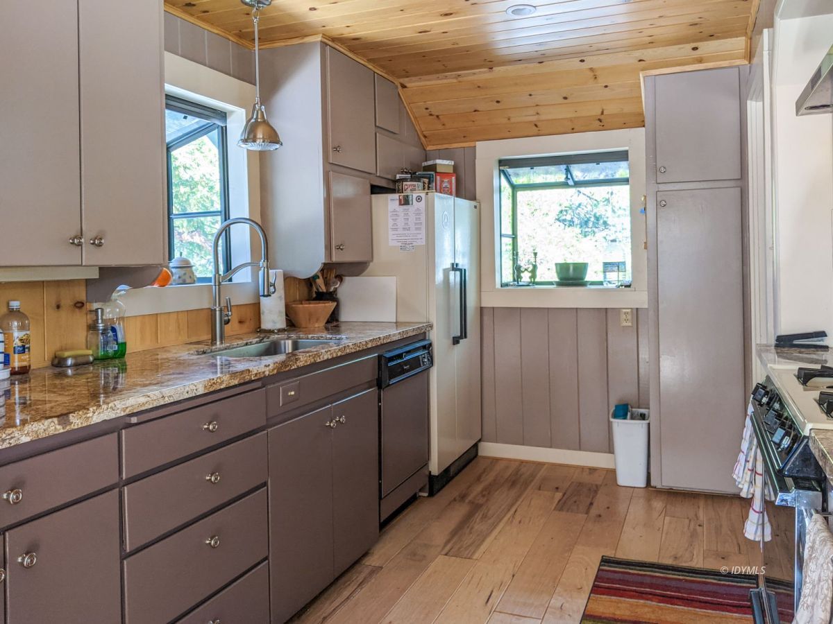 25505 Seneca Road Idyllwild, CA 92549 - Photo 24 of 60 a kitchen with granite countertop a refrigerator and a sink