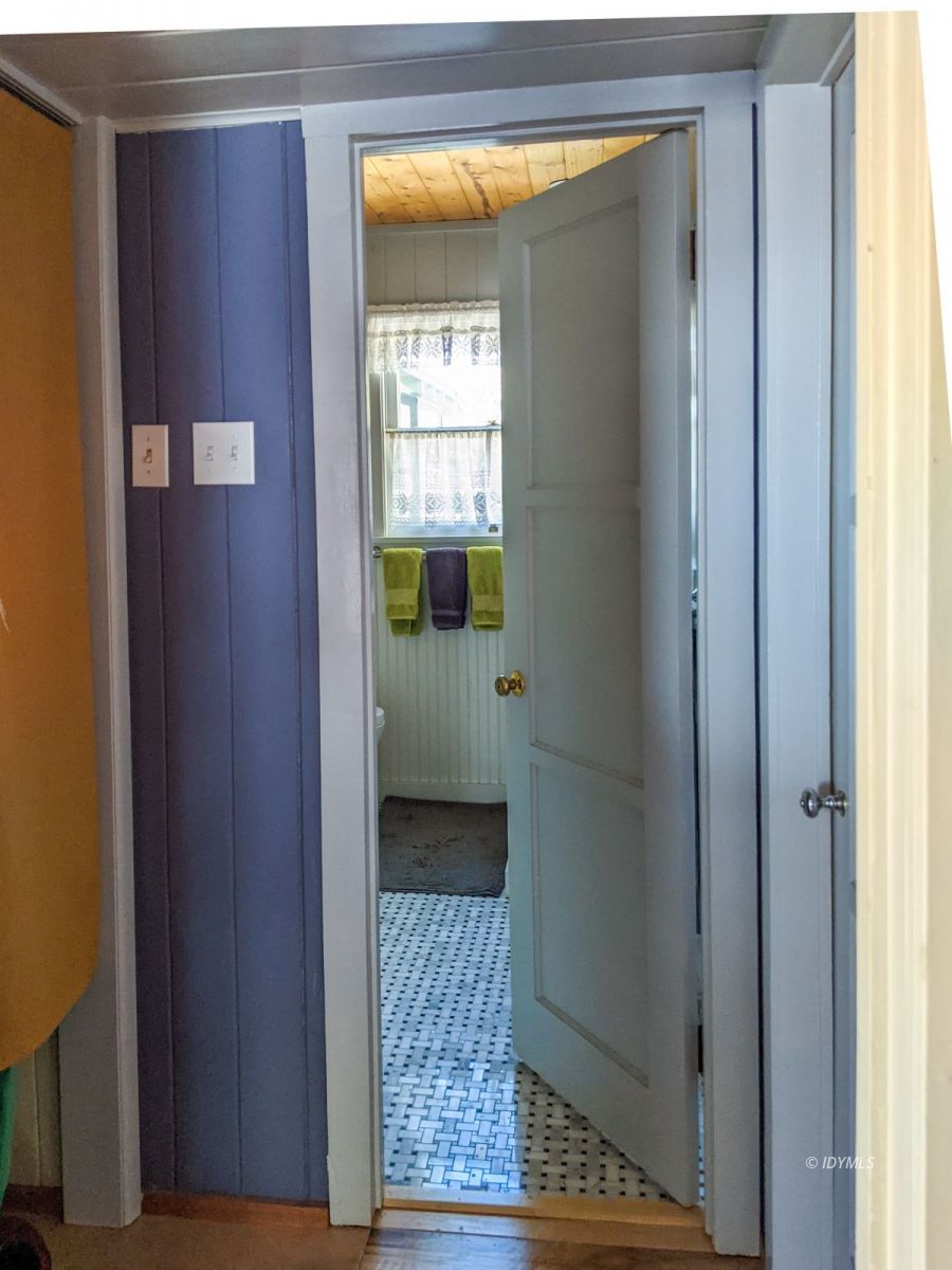 25505 Seneca Road Idyllwild, CA 92549 - Photo 32 of 60 a view of a hallway with wooden floor and a living room