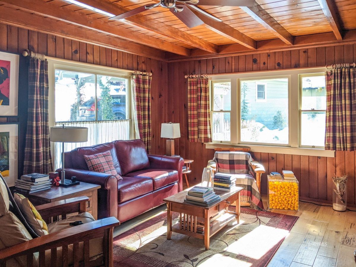 25505 Seneca Road Idyllwild, CA 92549 - Photo 36 of 60 a living room with furniture and a floor to ceiling window