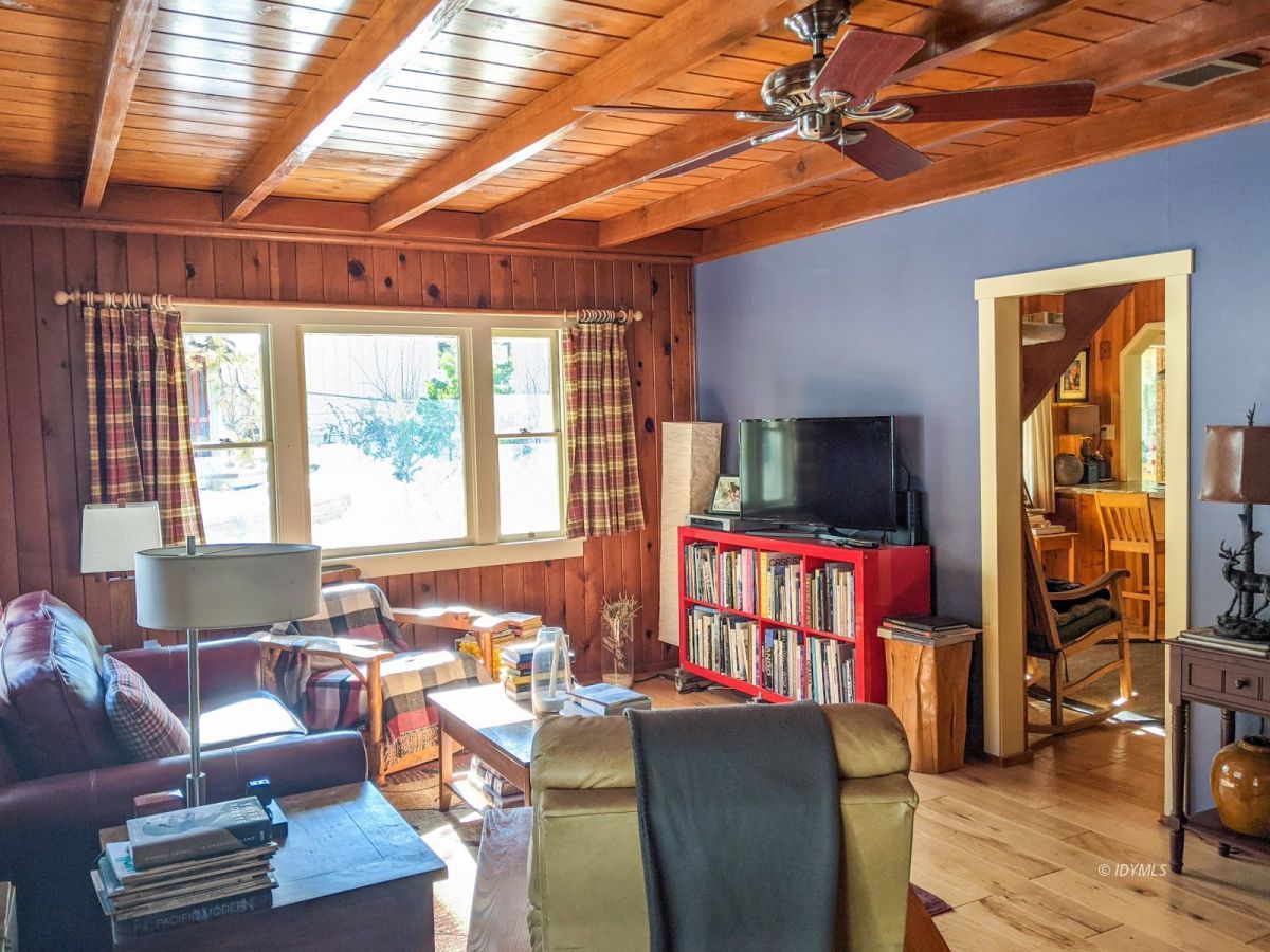 25505 Seneca Road Idyllwild, CA 92549 - Photo 38 of 60 a living room with furniture a flat screen tv and floor to ceiling window