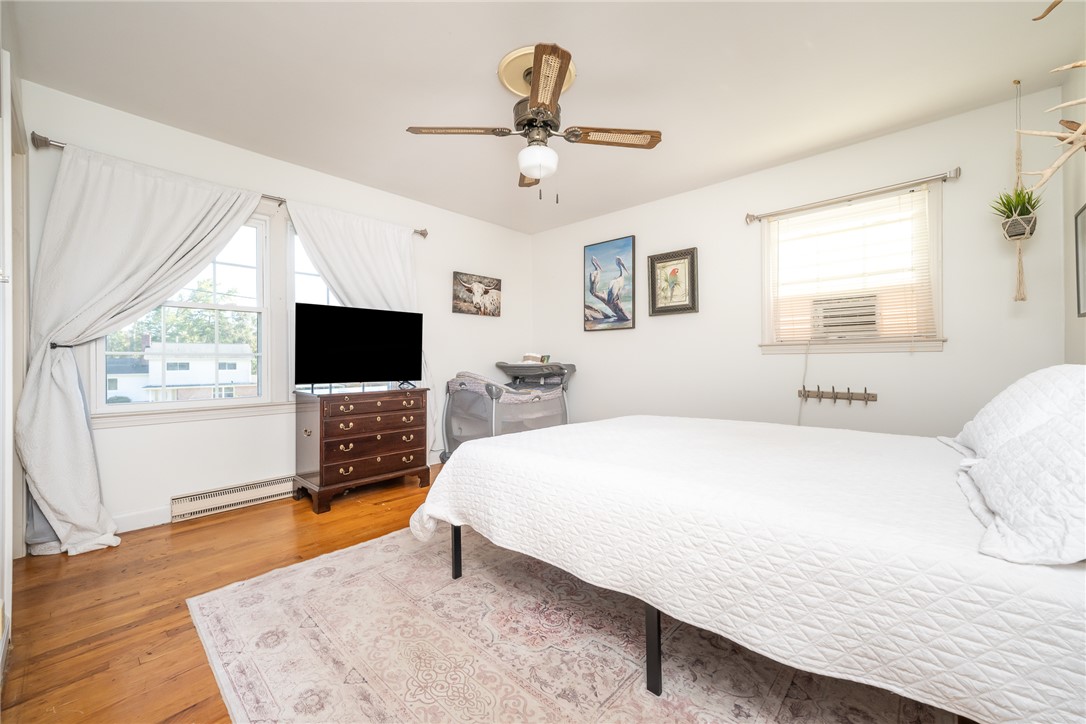 401 South Glassy Mountain Road Pickens, SC 29671 - Photo 9 of 37 This spacious bedroom features ample natural light and elegant hardwood floors.