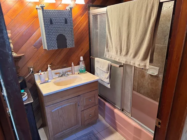 a bathroom with a sink a mirror and shower