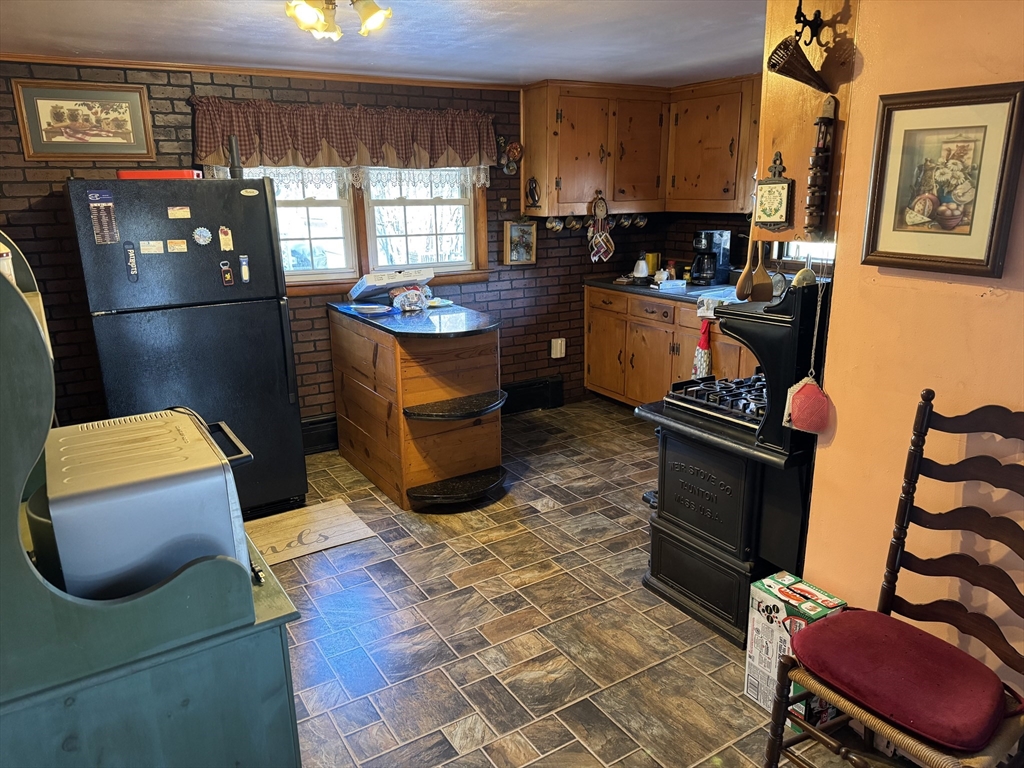 99 Leland Road Norfolk, MA 02056 - Photo 12 of 16 a kitchen with stainless steel appliances kitchen island granite countertop a stove and a refrigerator