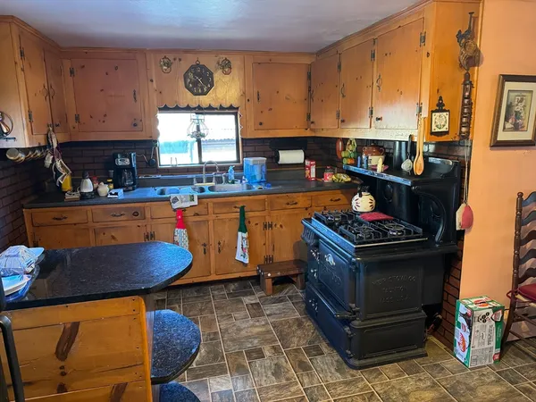 a kitchen with stainless steel appliances granite countertop a stove a sink and a refrigerator