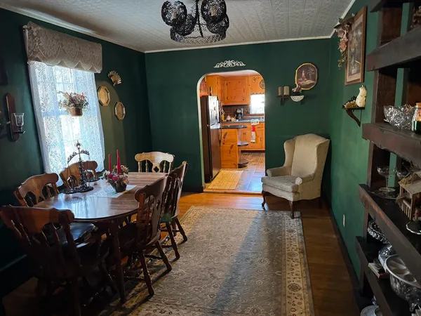 a dining room with furniture and wooden floor