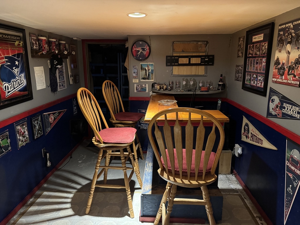 99 Leland Road Norfolk, MA 02056 - Photo 5 of 16 a living room with furniture a rug and a bookshelf