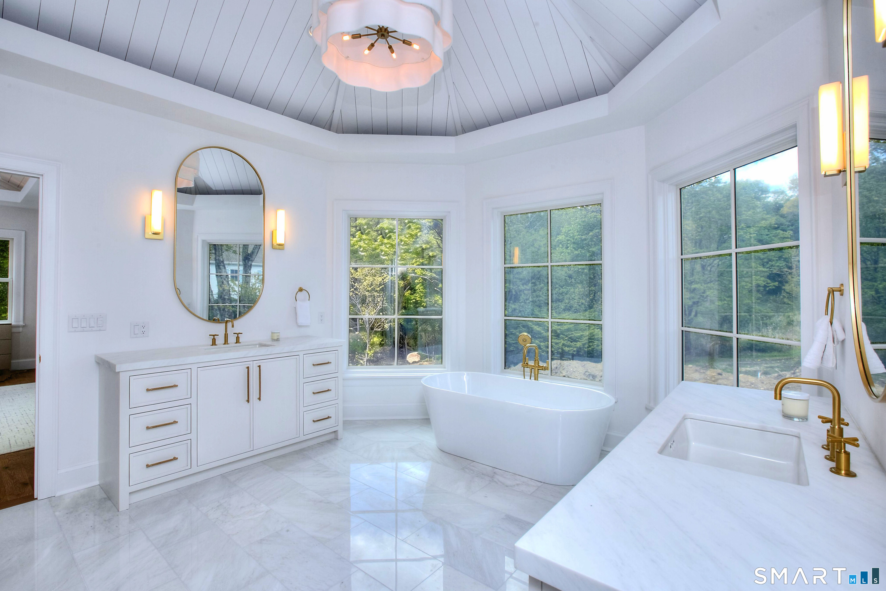 48 Kettle Creek Road Weston, CT 06883 - Photo 24 of 40 a spacious bathroom with a window double vanity sink and a mirror