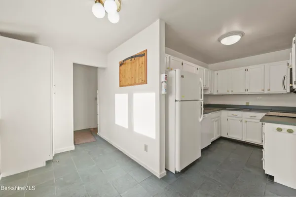a white refrigerator freezer sitting in a kitchen