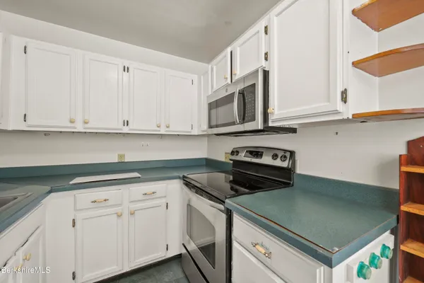 a kitchen with stainless steel appliances granite countertop a sink and a stove