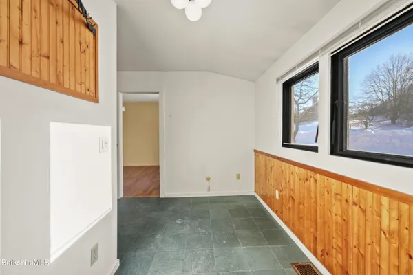 a view of a hallway with wooden floor and stairs