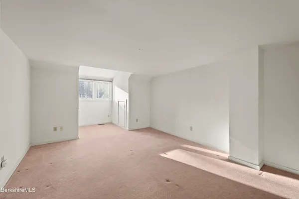 a view of an empty room with windows