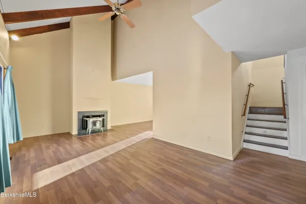 a view of a livingroom with wooden floor and white walls