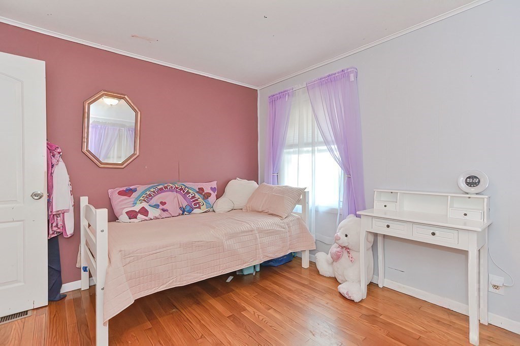 10 Rydal Street Worcester, MA 01602 - Photo 28 of 42 a bedroom with a bed and a chair