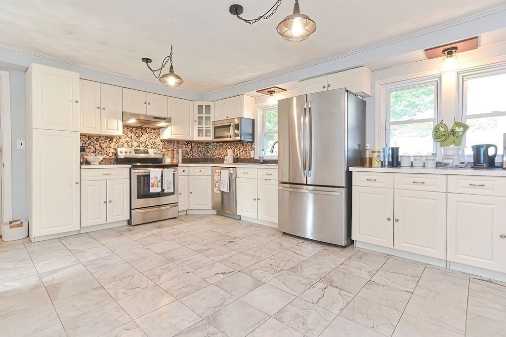 10 Rydal Street Worcester, MA 01602 - Photo 6 of 42 a kitchen with white cabinets and stainless steel appliances