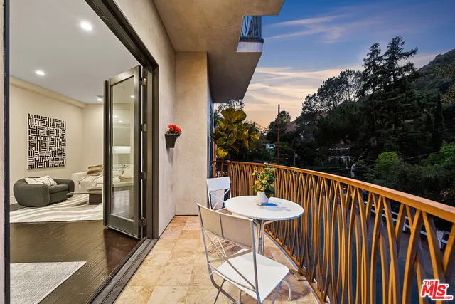 a balcony with table and chairs