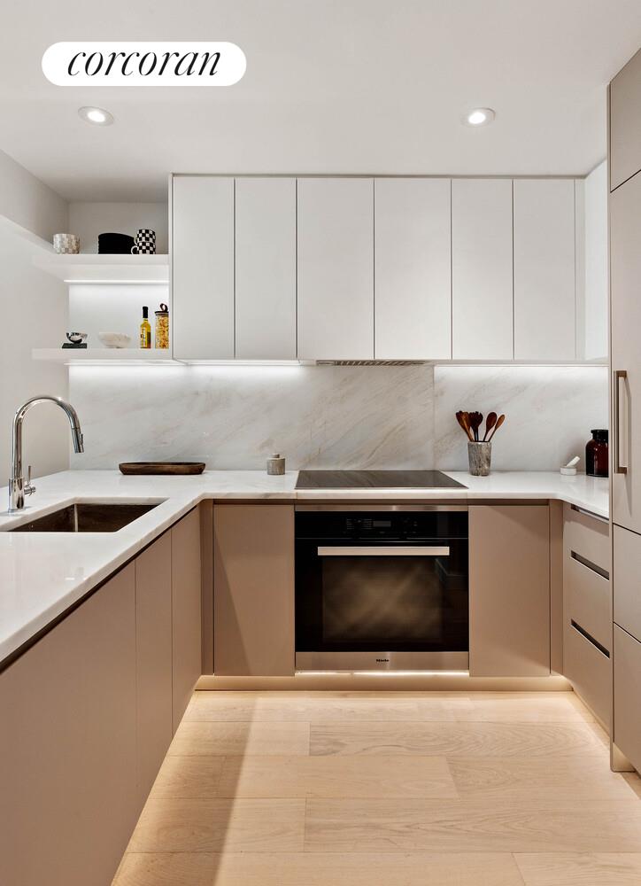 355 West 39th Street, Unit 6A Manhattan, NY 10018 - Photo 4 of 9 a kitchen with a sink cabinets and stainless steel appliances
