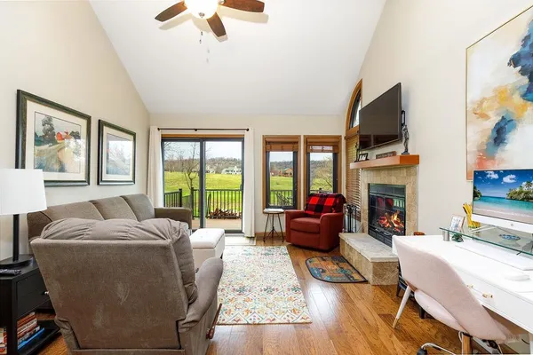a living room with furniture fireplace and flat screen tv