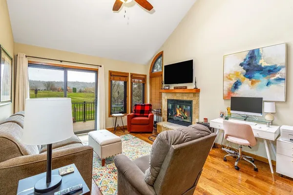 a living room with furniture fireplace and flat screen tv