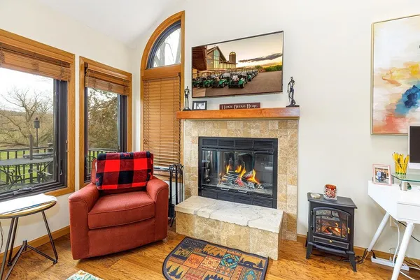 a living room with furniture a flat screen tv and a fireplace