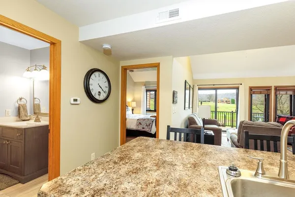 a living room with furniture a large window and flat screen tv