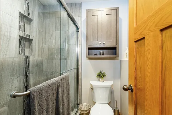a white toilet sitting next to a bathroom sink