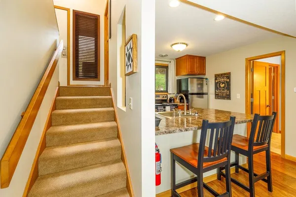 a view of entryway and hall with wooden floor